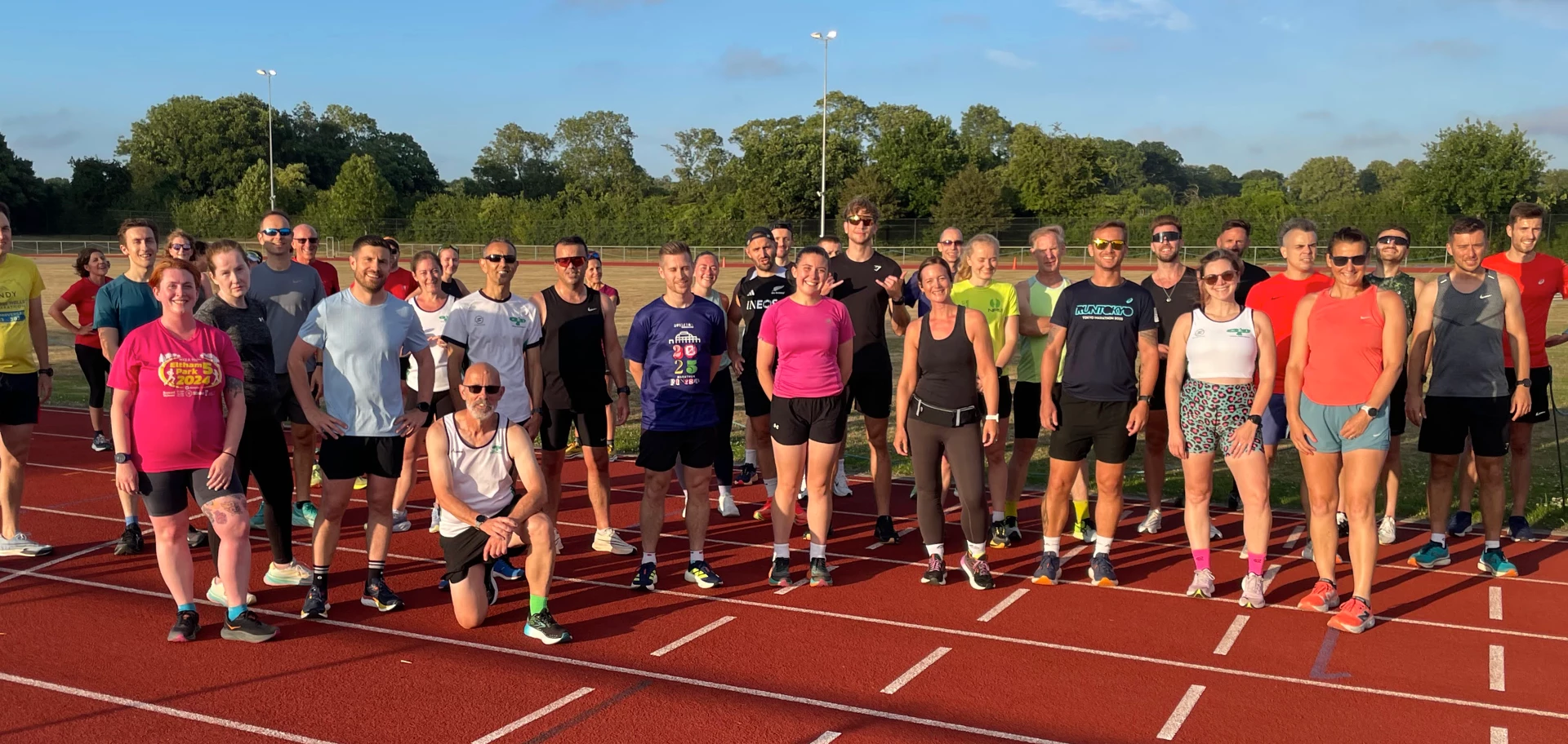 Maidstone Harriers Tuesday evening track session with runners posing for a pre-training photo
