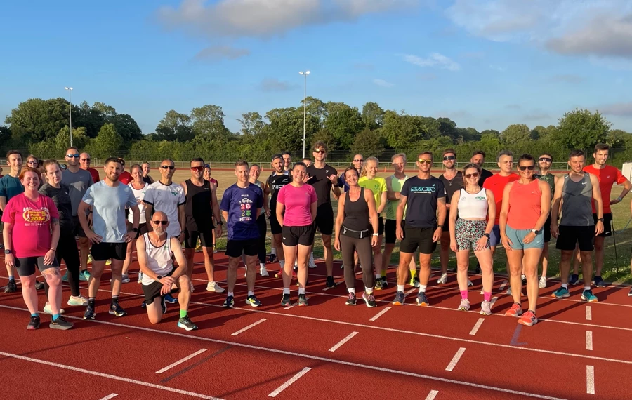 Maidstone Harriers Tuesday evening track session with runners posing for a pre-training photo