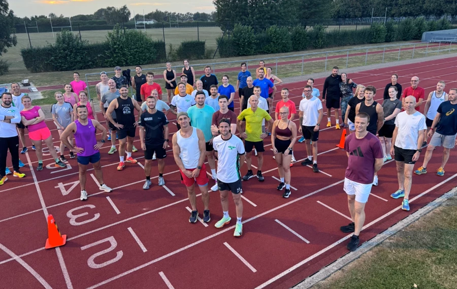 Maidstone Harriers Tuesday evening track session with runners posing for a pre-training photo