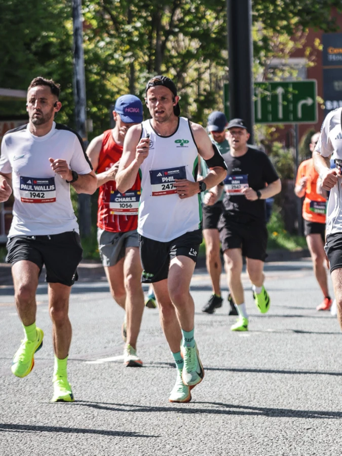 Phil Edmonds racing on the road in a Maidstone Harriers club vest.