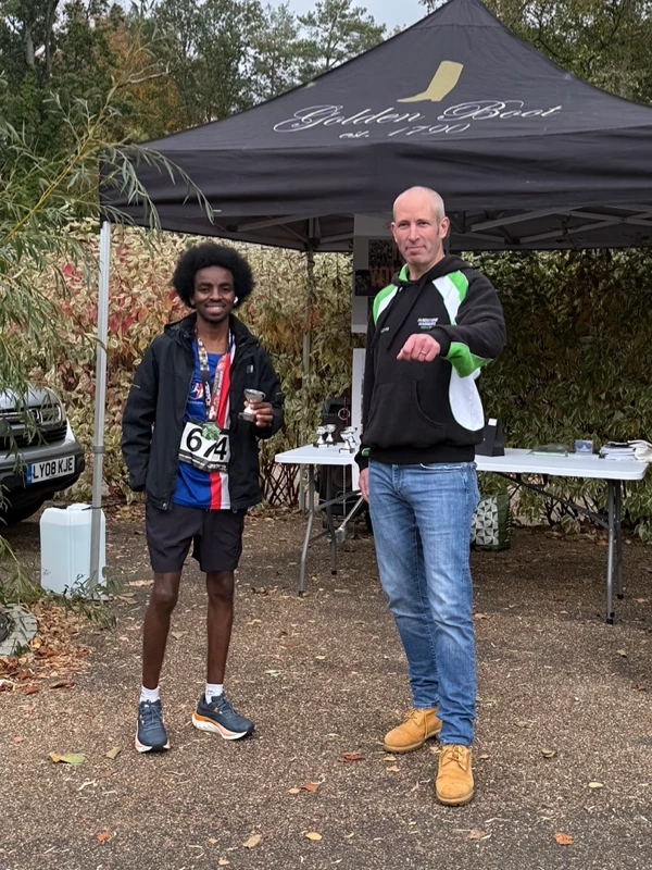 Maidstone Half Marathon medalist, Nasradine-Haroun, getting their trophy in the 2025 event. Hosted by the Maidstone Harriers Run and Tri Club