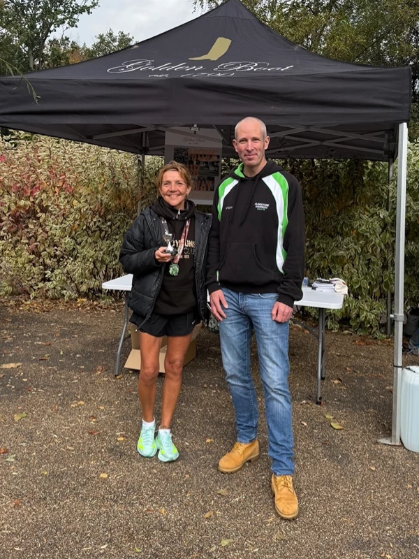 Maidstone Half Marathon medalist getting their trophy in the 2025 event. Hosted by the Maidstone Harriers Run and Tri Club