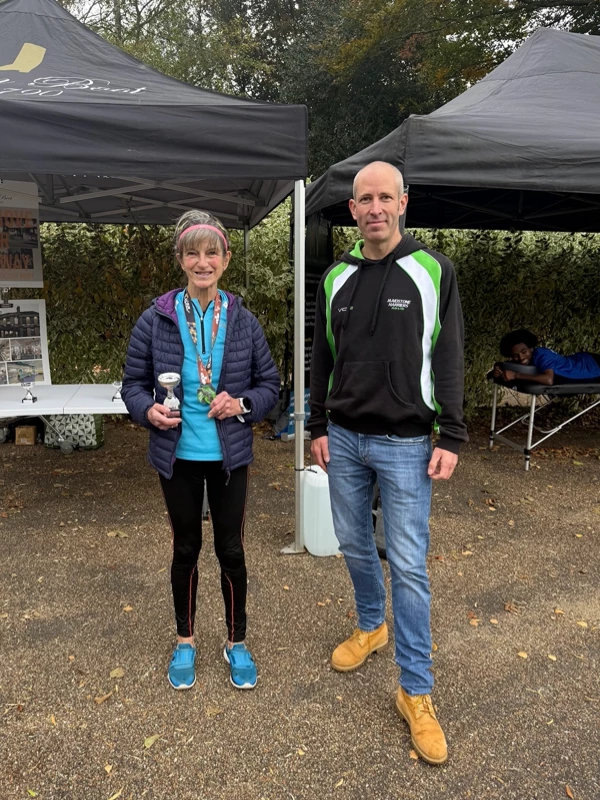 Maidstone Half Marathon medalist getting their trophy in the 2025 event. Hosted by the Maidstone Harriers Run and Tri Club