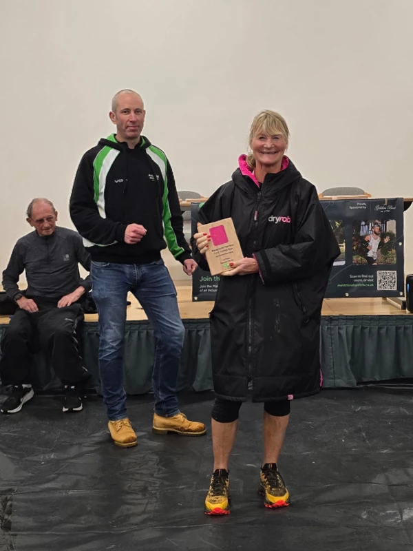 Turkey Run medalist getting their trophy in the 2024 event. Hosted by the Maidstone Harriers Run and Tri Club