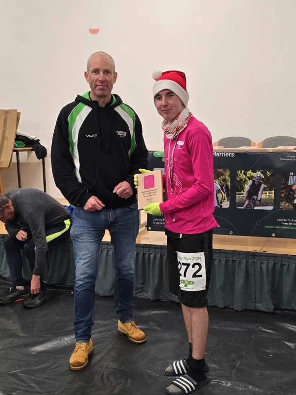 Turkey Run medalist getting their trophy in the 2024 event. Hosted by the Maidstone Harriers Run and Tri Club