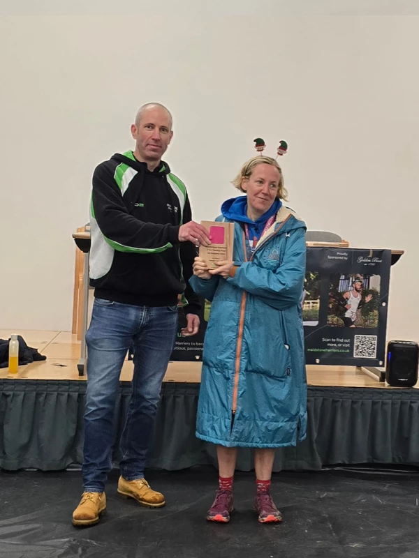 Turkey Run medalist getting their trophy in the 2024 event. Hosted by the Maidstone Harriers Run and Tri Club