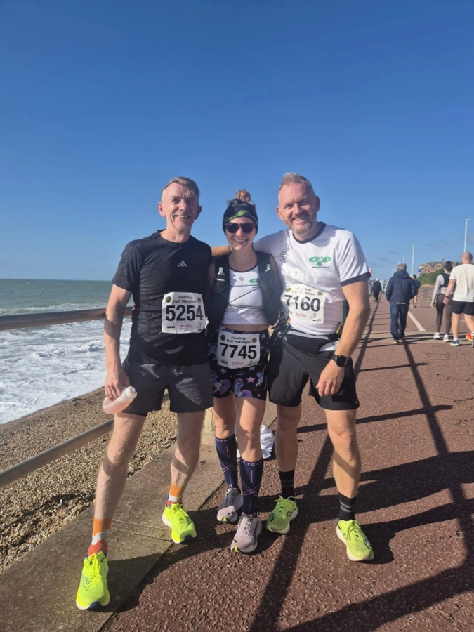 Anthony Bishop with Maidstone Harriers teammates, Kerry and Tony, on the Hastings seafront after the Hastings Half Marathon
