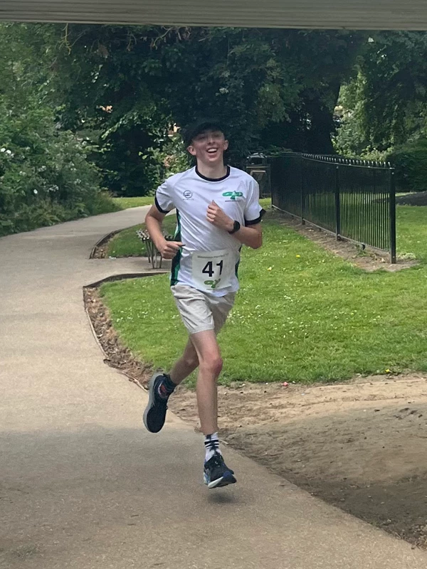 Sam Flood smiling as he leads the field at the 2025 Maidstone Harriers David Thornby 10k