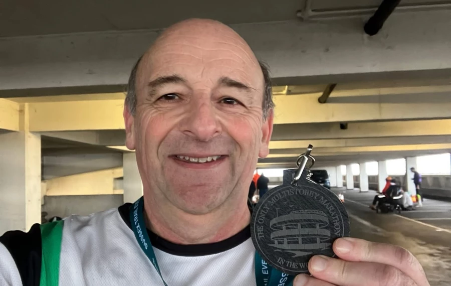 Maidstone Harriers runner Andrew Burgess holding his medal after completing the Southend multi-storey car park marathon