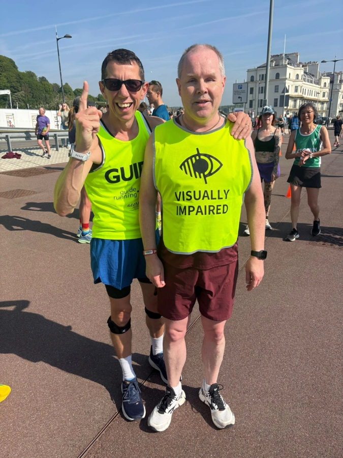 Nick Bailey standing with blind runner Barry Ginley of Maidstone Harriers at parkrun