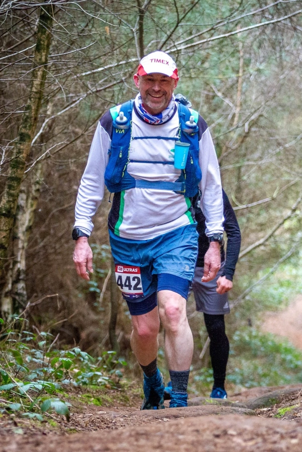 Michael White running a wooded trail during the GB Ultras Scotland Ultra 50