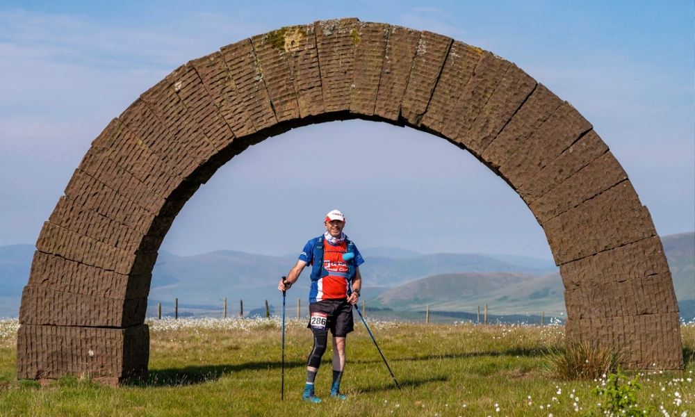 Michael White standing beneath a stone arch during the GB Ultras Scotland Ultra 50 in June 2023