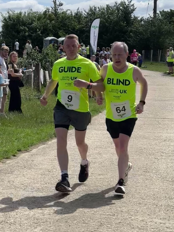 Guided runner Barry Ginley crossing the finish line at the 2026 Maidstone Harriers David Thornby 10k.