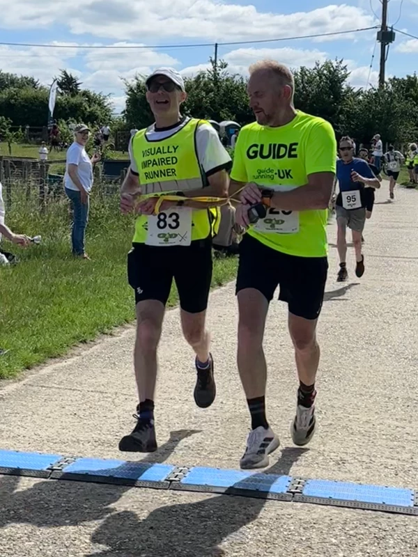 Guided runner Roger Hyland crossing the finish line at the 2026 Maidstone Harriers David Thornby 10k.
