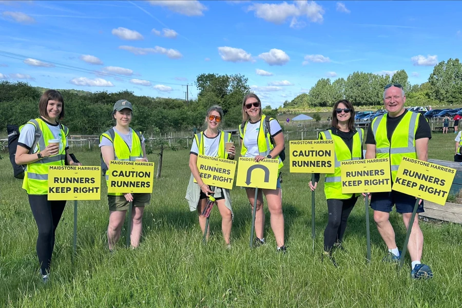 Maidstone Harriers volunteers holding caution runners signs at the 2026 David Thornby 10k.