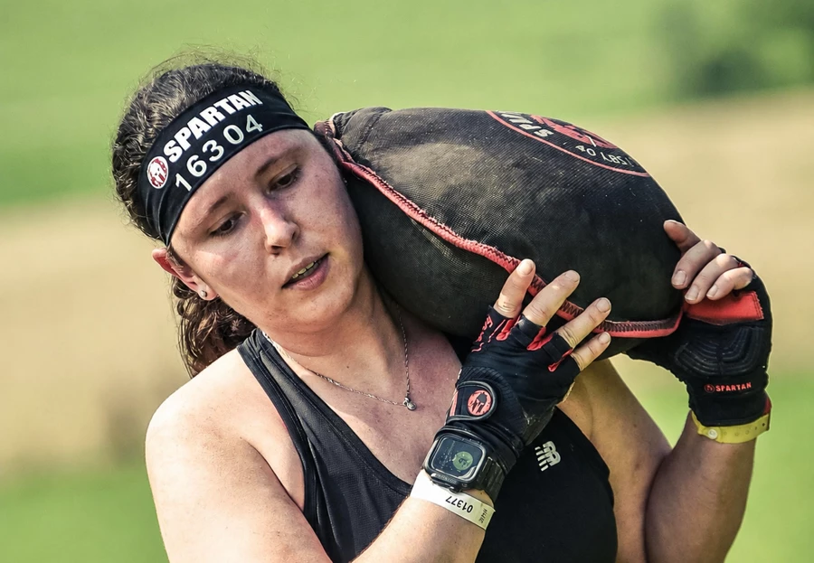 Debbie Addison carrying a sandbag during a Spartan race.