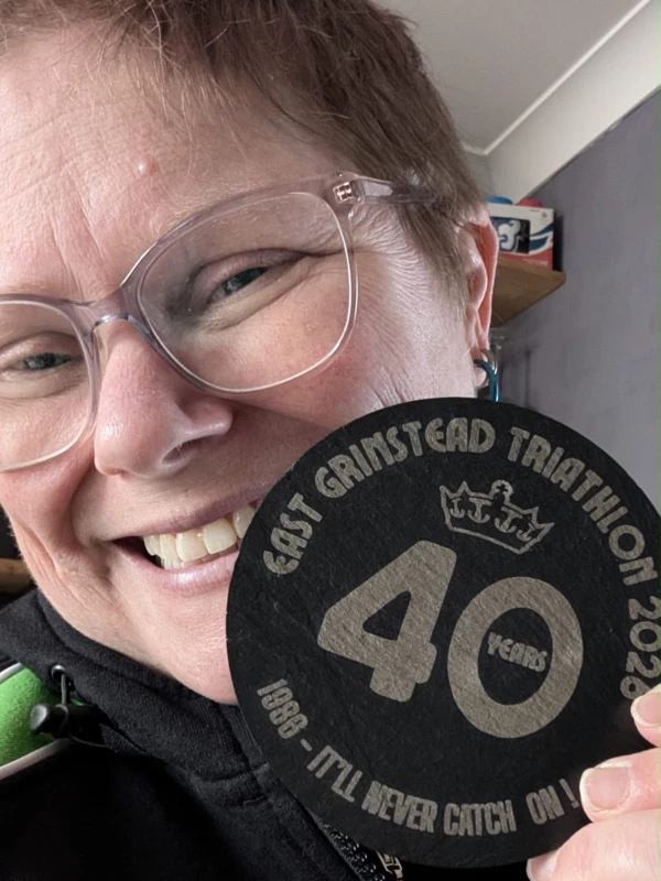 Catey Bowles smiling with her East Grinstead Triathlon 2026 40 years medal