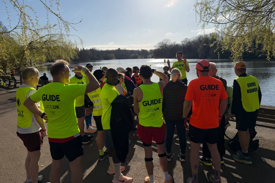 Maidstone Harriers guide runners and visually impaired runners gathering for a briefing by Gemma Prowse ready for Mote Park parkrun