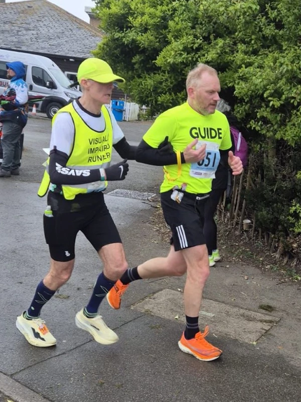 Roger Hyland of Maidstone Harriers running with a guide runner Tony Potter, at the 2026 Folkestone 10 Miler.