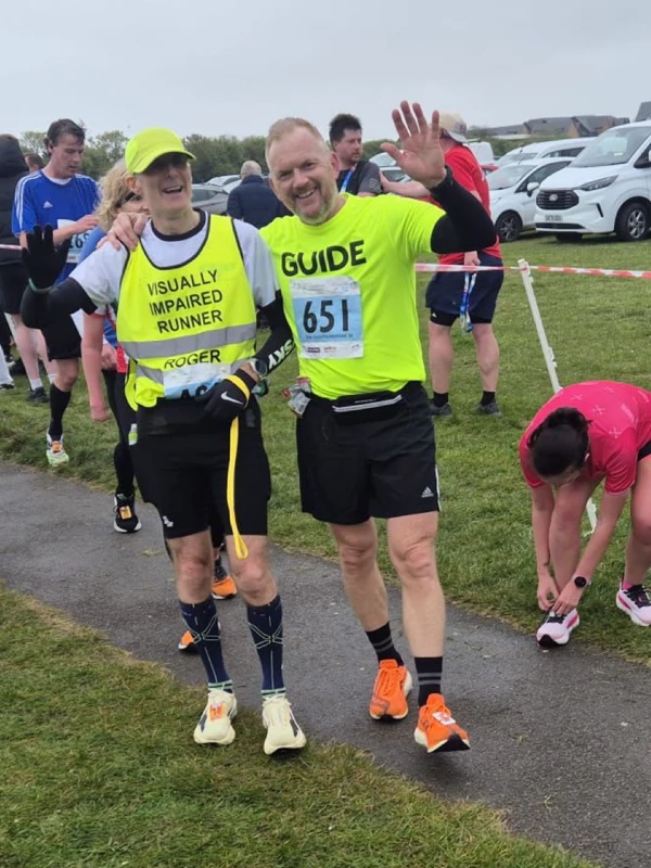 Roger Hyland of Maidstone Harriers running with a guide runner Tony Potter, at the 2026 Folkestone 10 Miler