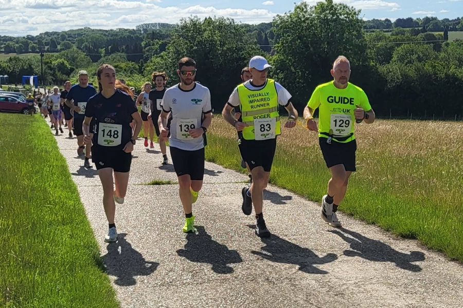 Roger Hyland and guide runner Tony Potter running with other competitors at the 2026 David Thornby 10k